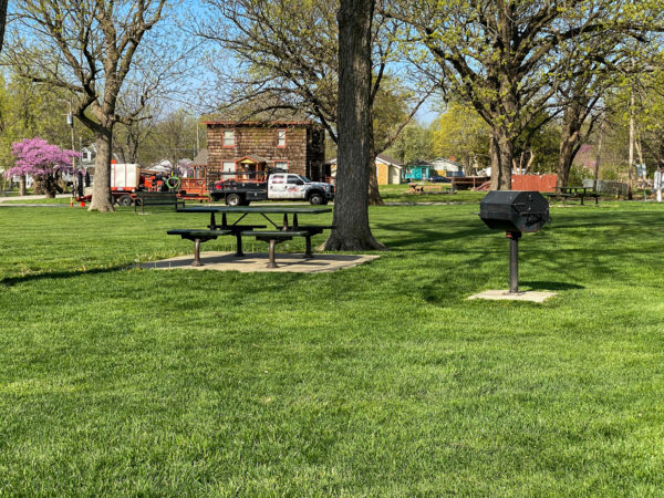 grills and picnic tables in the center of city park