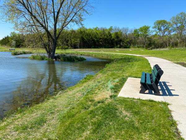 lake and benches at veterans park on walk path