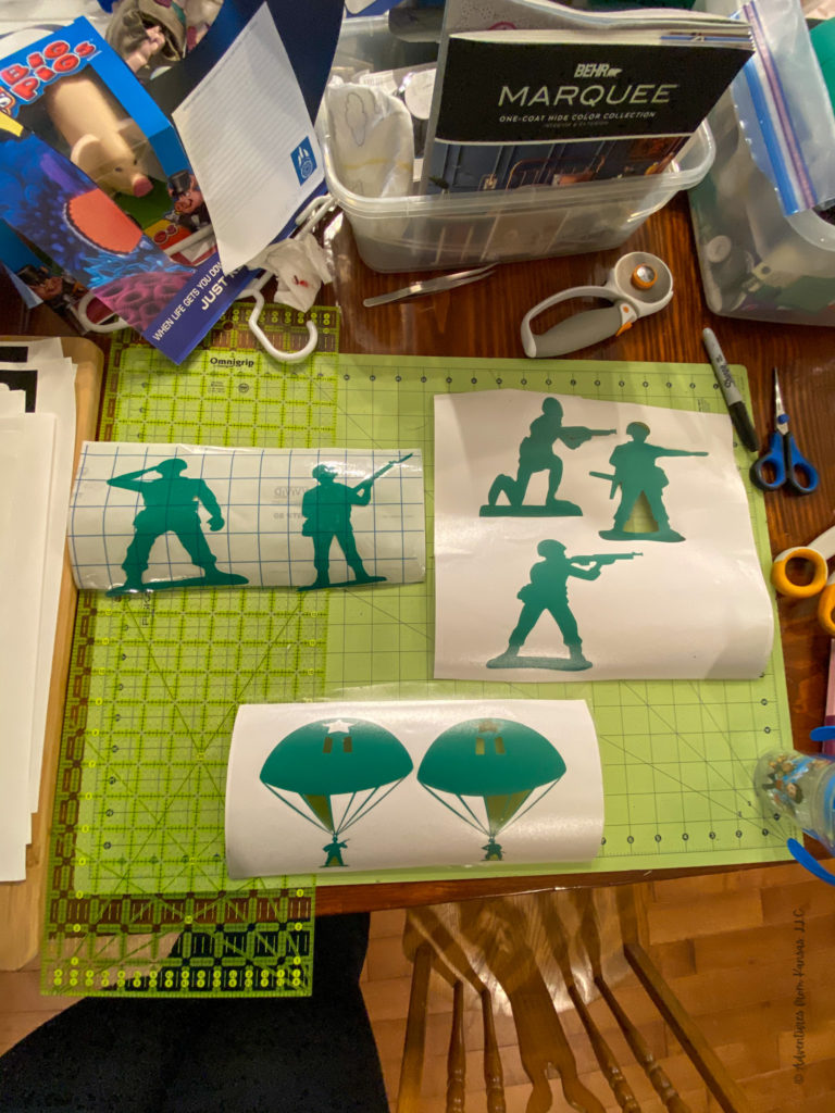 army guys cut out of green vinyl sitting on a cutting mat