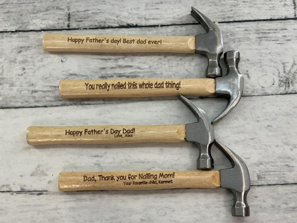 wood background with hammers that are engraved