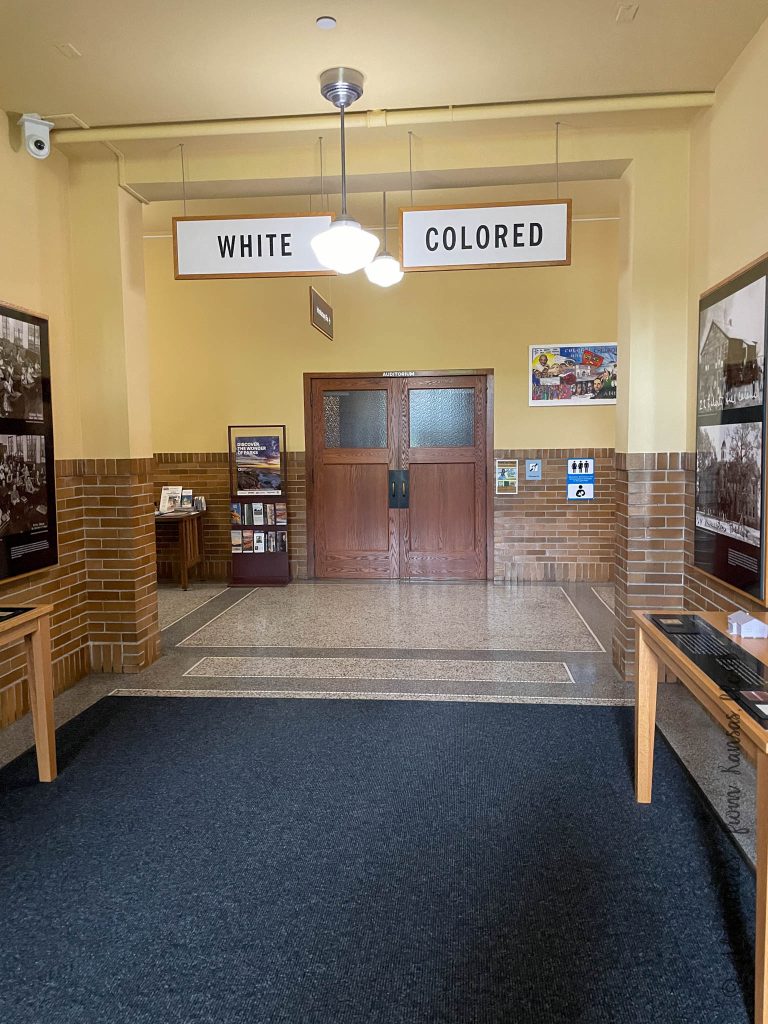 Entrance of Monroe School in Topeka KS, part of Brown Vs Education - showing signs White & Colored