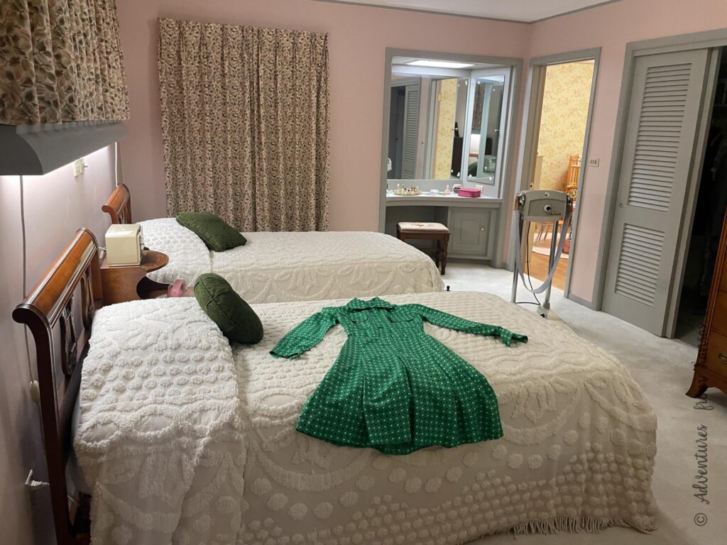 twin beds with green dress laying on the bed